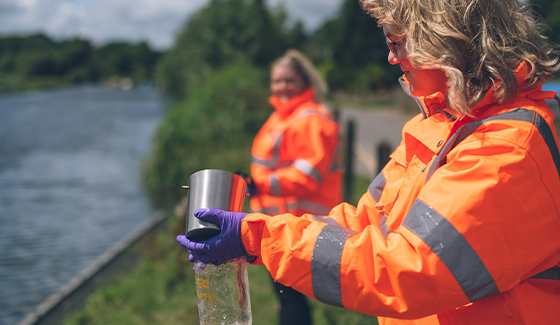 Employees taking water samples